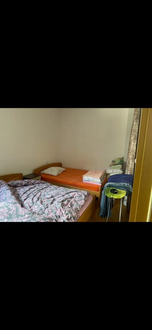 Bedroom with two beds and bedding.