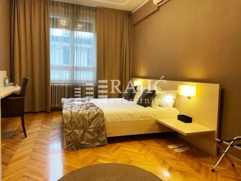 Furnished bedroom with a double bed, desk, and parquet flooring. - image 3