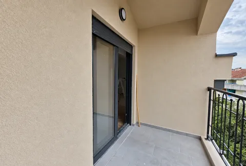 Covered balcony with tiled flooring and sliding balcony doors. - image 14