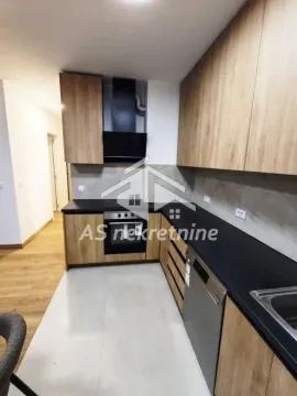Modern kitchen with wooden cabinetry and built-in appliances. - image 27