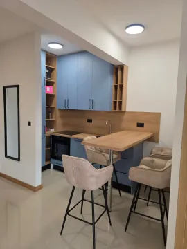 Moderna kuhinja sa plavim elementima, šankom i stolicama za sjedenje. - image 10