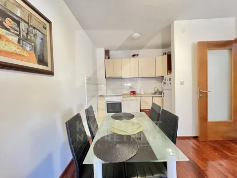 Kitchen with a dining area equipped with basic elements and a dining table. - image 4