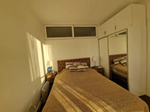 Furnished bedroom with a double bed and a fitted wardrobe. - image 4