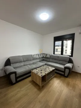 Living room with a sectional sofa and a coffee table. - image 11