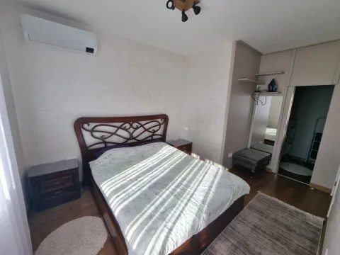 Bright bedroom with a double bed, nightstands, and a built-in wardrobe. - image 4