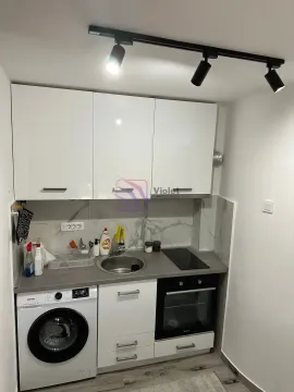 Small kitchen with a sink, oven, stovetop, and integrated washing machine. - image 6