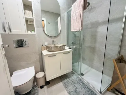 Modernly equipped bathroom with a shower cabin and a sink. - image 11