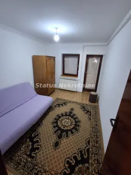 Furnished bedroom with a bed, wardrobe, and rug. - image 13
