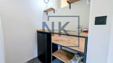 Small kitchen with a sink, countertop, and mini fridge. - image 7