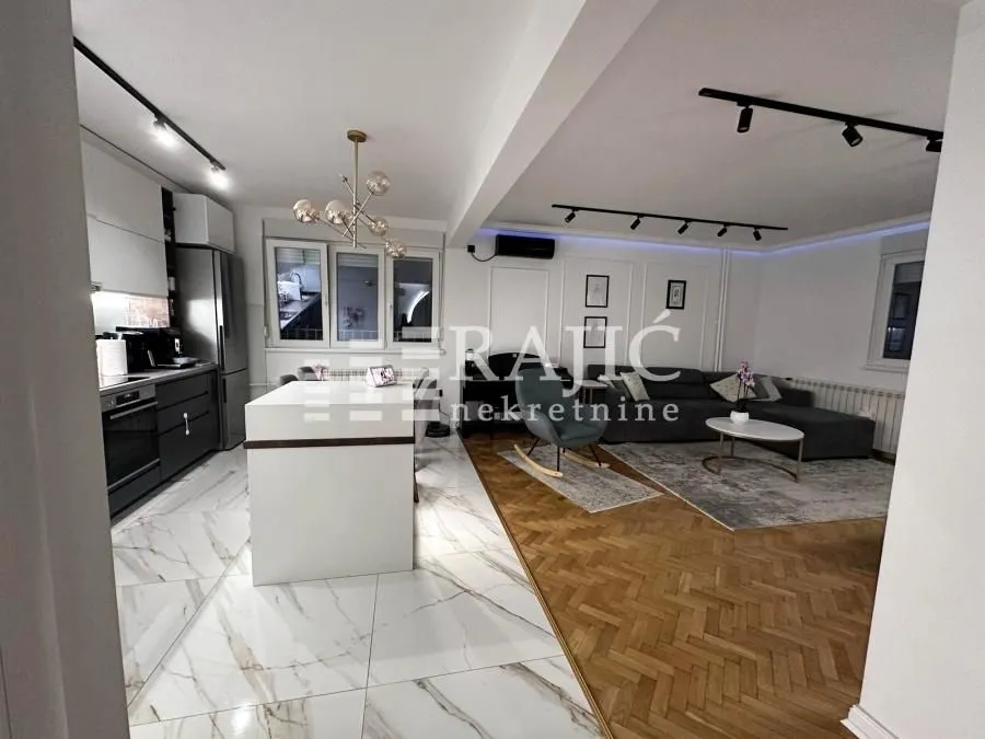 Modern living room connected to the kitchen and dining area.