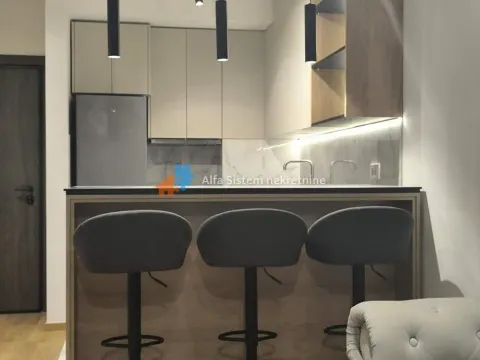 Modern kitchen with a breakfast bar and three bar stools. - image 13