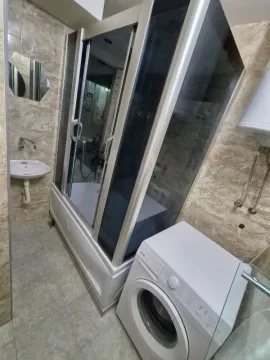 Bathroom with shower cabin, washbasin and washing machine. - image 9