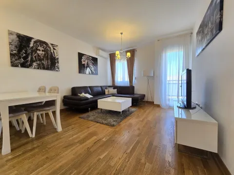 Spacious living room with a sofa set, dining table, and access to the terrace. - image 2