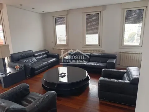 Spacious living room furnished with black leather seating and a round coffee table. - image 18