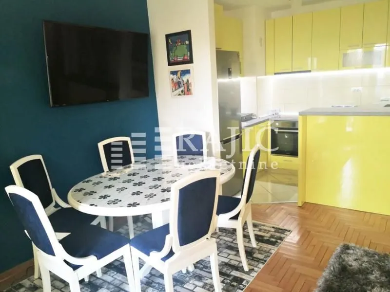 Dining area with a table and chairs connected to the kitchen.