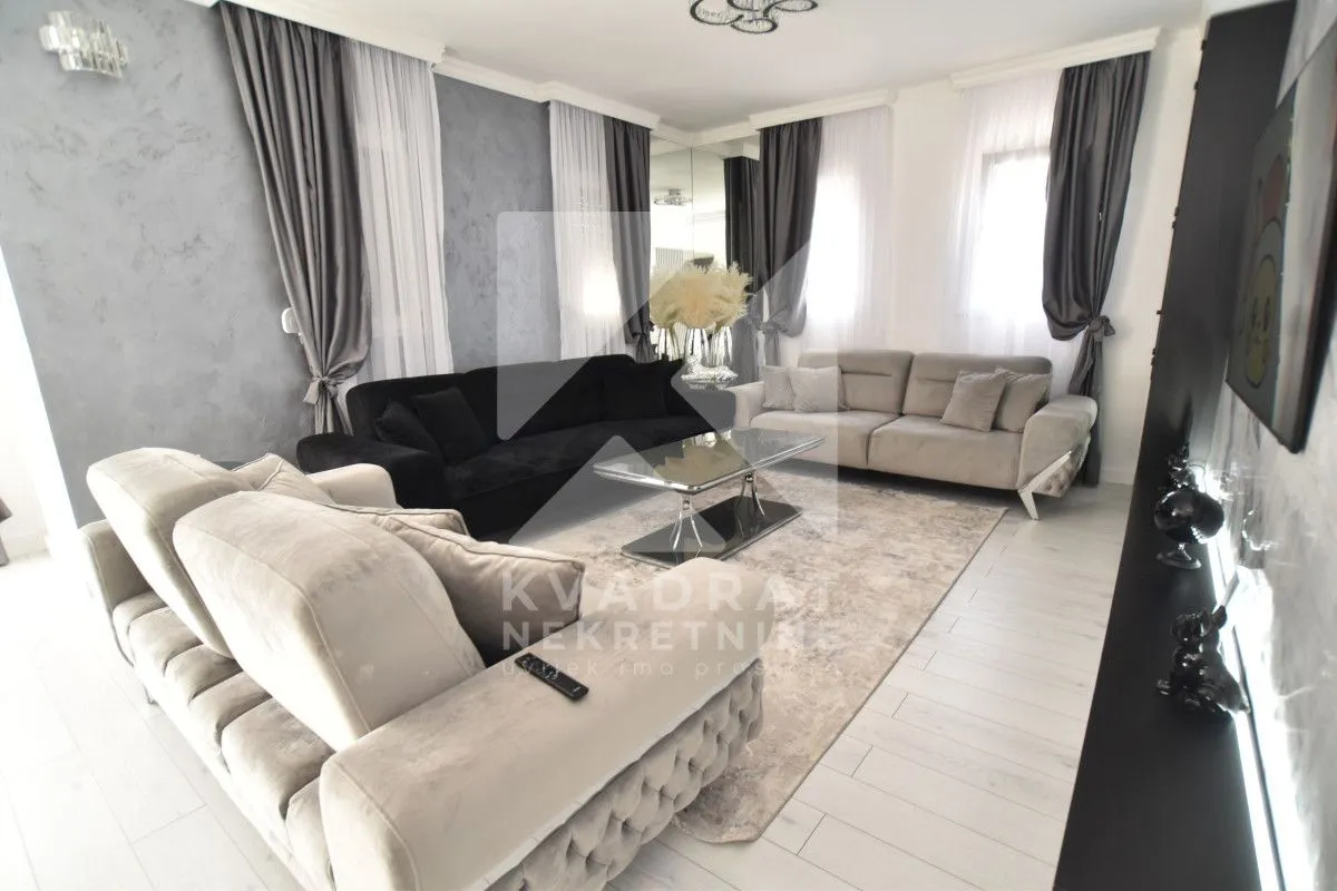 Spacious living room with seating set and modern furniture.