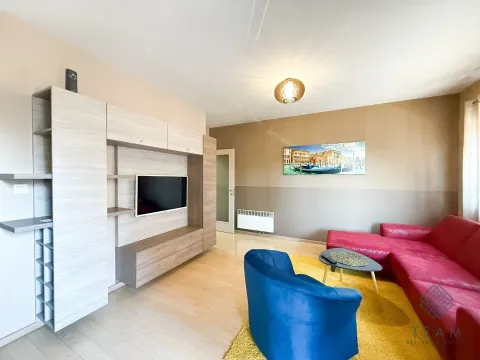 Living room with a sofa set, TV unit, and parquet flooring. - image 3