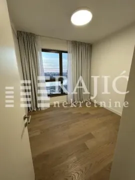 Empty bedroom with a window and wooden flooring. - image 15