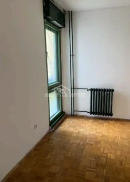 Empty room with parquet flooring, a window, and a radiator. - image 8