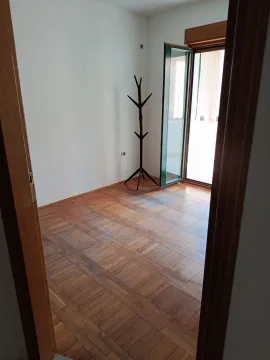 Empty room with wooden flooring and access to the terrace. - image 3