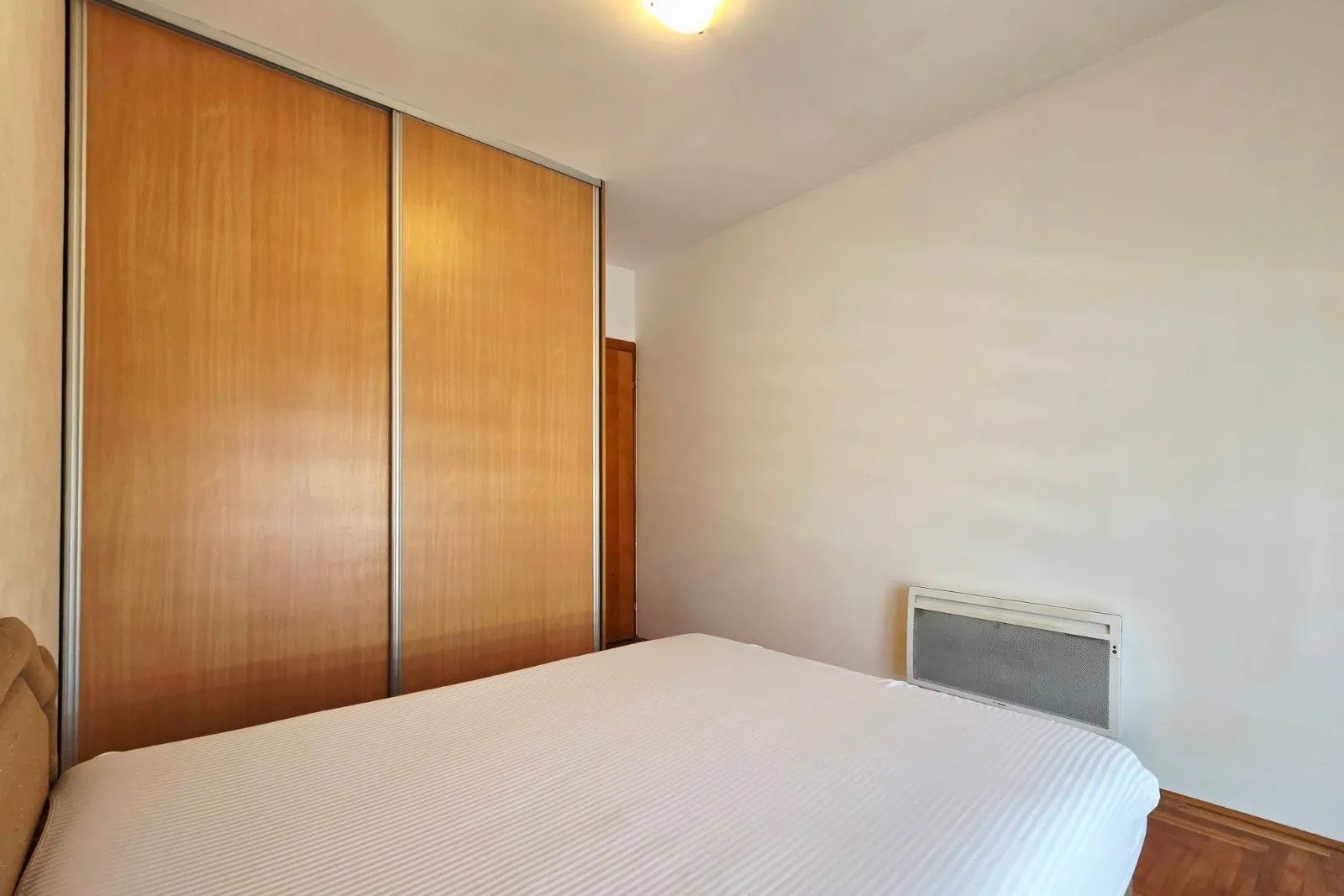 Bedroom with a double bed and a built-in wardrobe.
