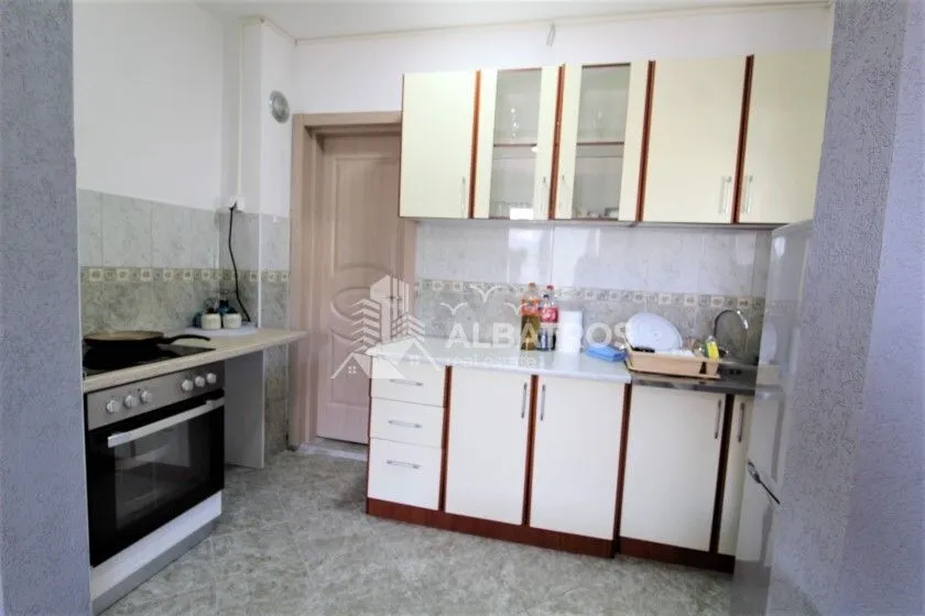 Small kitchen with cabinets and built-in appliances.