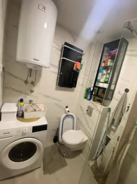 Manje kupatilo sa tuš kabinom, veš mašinom i ugrađenim sanitarijama. - image 13