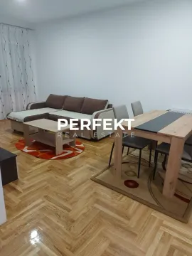 Living room with a sofa and a dining table. - image 2