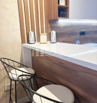 Modern kitchen with a breakfast bar and bar stools. - image 2