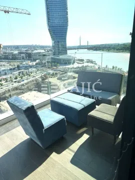 Furnished terrace with seating set and a view of the river and city. - image 10