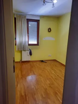 View from the doorway into an empty room with yellow walls and parquet flooring. - image 6