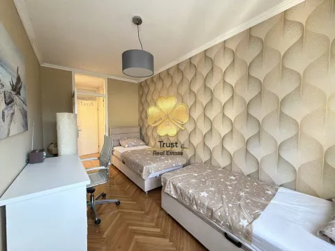Bedroom with two beds and a desk. - image 15