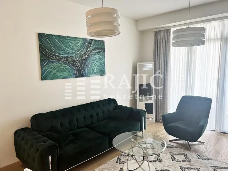 Modern and bright living room with a sofa and an art painting on the wall.