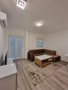 Bright living room with a corner sofa and a coffee table. - image 2