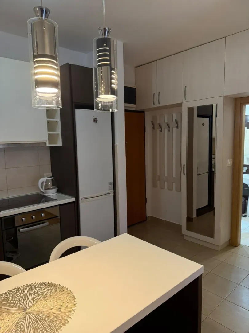 Small kitchen with a dining table and built-in appliances.