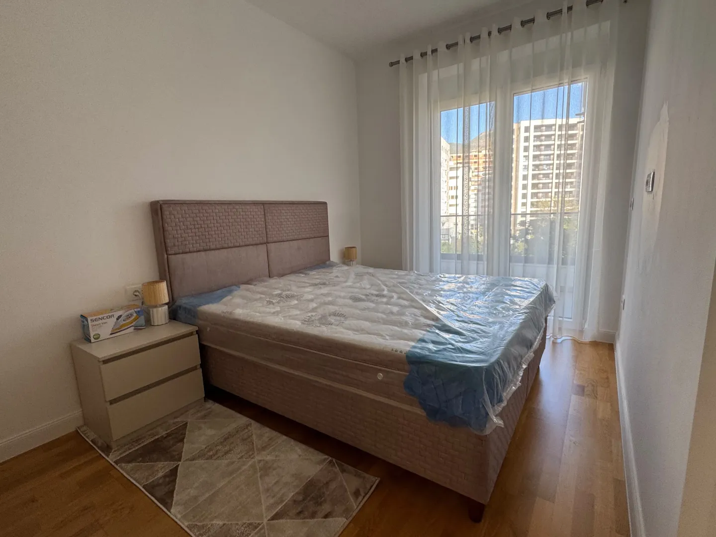 Bedroom with a double bed and balcony access.