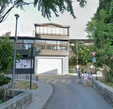 View of the exterior of the building with a street and sidewalk. - image 4