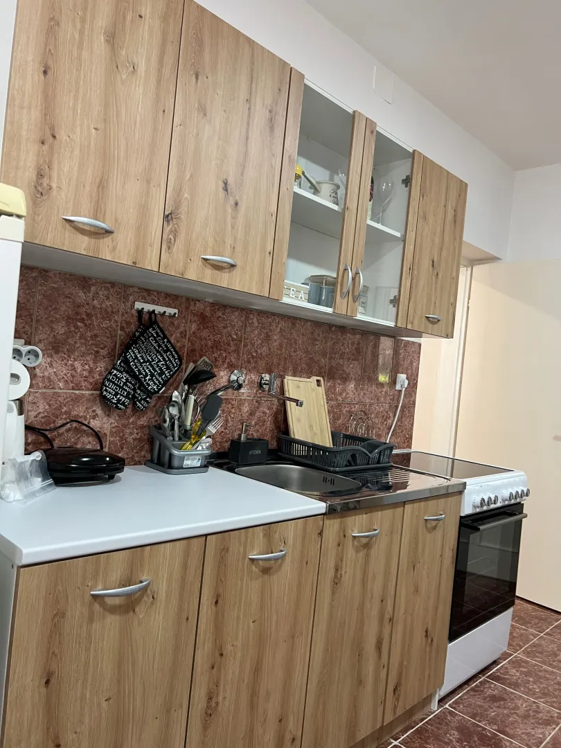 Smaller kitchen with wooden cabinetry and a stove.