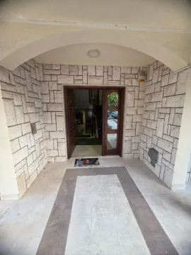 Main entrance of the building with stone facade cladding. - image 2