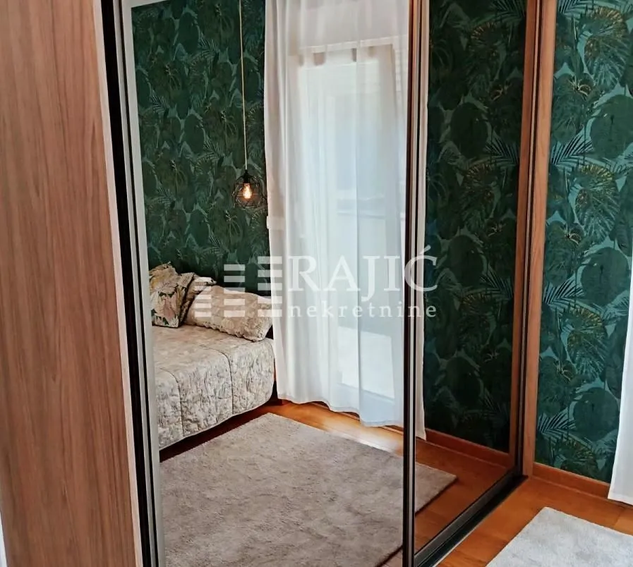 View of the bedroom through a wardrobe mirror.