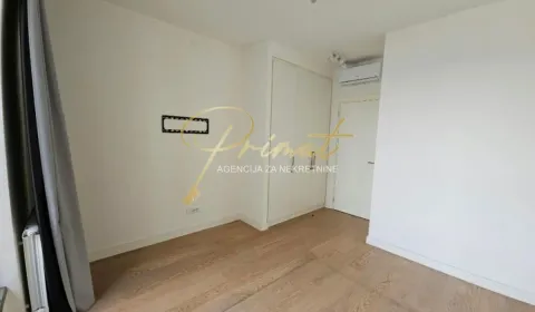 Empty bedroom with a built-in wardrobe, air conditioning, and wooden flooring. - image 6