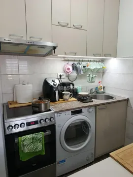 Compact equipped kitchen with a stove, sink, and integrated washing machine. - image 6