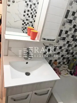 Bathroom with a sink and a mirror. - image 8