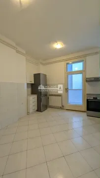 Small kitchen with a refrigerator, stove, and access to the terrace. - image 11