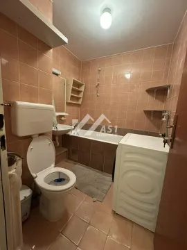 Kupatilo obloženo keramičkim pločicama sa kadom, toaletom i veš mašinom. - image 4