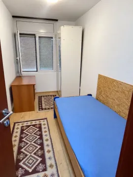 Smaller bedroom with a bed, wardrobe, and desk. - image 8