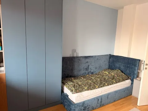 Bedroom with a bed and a blue wardrobe. - image 6