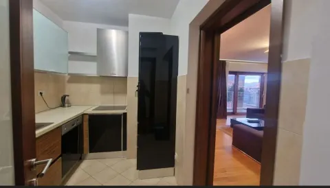 A functional kitchen with a view into the spacious living room. - image 8