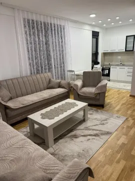 Living room with a sofa set and dining area in an open-plan layout. - image 5
