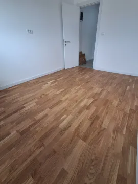 Empty room with parquet flooring and white walls. - image 3